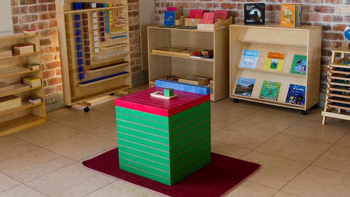 Prepared Montessori environment, wide shot with natural light