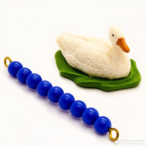 The featured image is of a female white duck. Laying next to the duck, is a dark blue, 9 bead stair, to illustrate the size of the duck. This bead stair can be purchased separately. The duck is part of the flock or family of ducks. This language object, forms part of an activity known as The Farm in the Montessori Language Curriculum. It can be purchased individually, or as part of the complete Farm activity.
