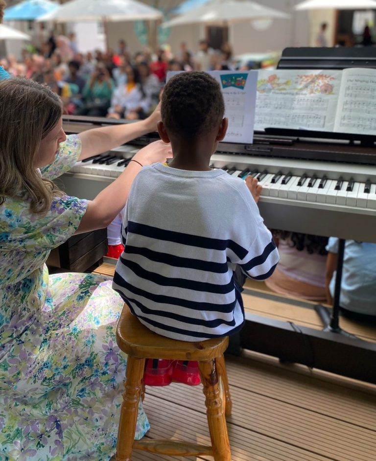 Auburn House Montessori School, a young pianist performing on stage.