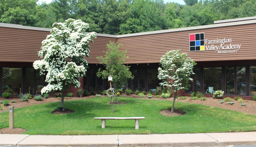 The picture depicts a hero image of the Farmington Valley Academy Montessori school, advertising for an Upper Elementary Guide. Located on a beautiful 11-acre campus of wooded land in Avon, CT. The school offers a "Farm Program" in partnership with Hall Farm and uses the surrounding environment for its botany and biology classes.