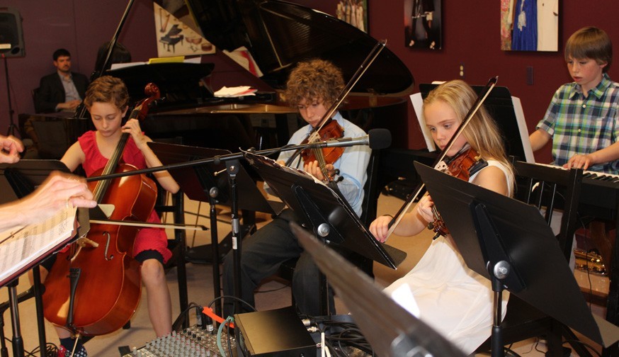 Farmington Valley Academy Montessori - Upper Elementary Guide. The school offers many extended classes to incorporate their 6 key area of work. In this case, the students are encouraged to join the bands, to incorporate their arts studies, with the hands on experience of performing live. Here you have a picture of the cellist, 2 violinists and a percussion keyboard set against a baby grand piano.