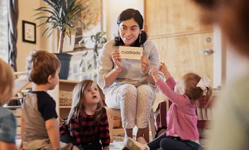 Montessori School of Raleigh - Teacher reading to toddlers at the 'reading Circle"